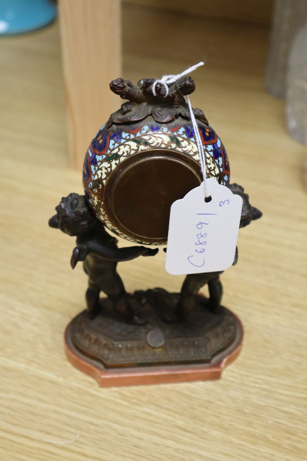 A putti and cloisonne bronze clock decorated with diamonte, height 19cm